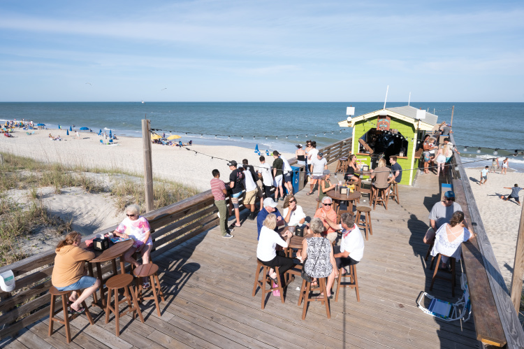 people walk about the Carolina Beach Boardwalk