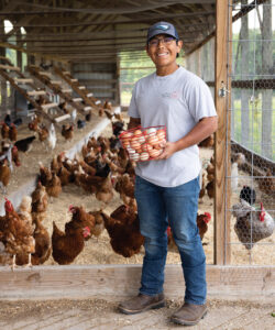 Talton Correll holding a basket of eggs