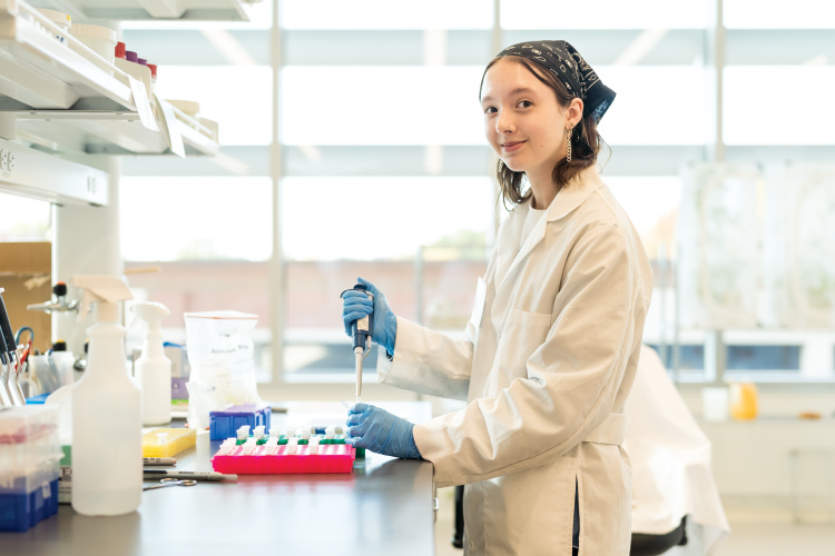 Claire Patrick works in the lab at the NC State Plant Sciences Building