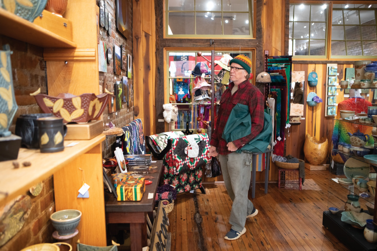 Ken Hamilton looks at artwork by local artists the Flow gallery in downtown Marshall. ©Journal Communications/Nathan Lambrecht