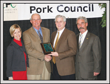 From left, Vicky Porter and Tommy Porter accept the North Carolina Pork Council’s 2009 'Outstanding Pork Producers' Award from Carolina Farm Credit CEO Mike Morton and North Carolina Pork Council President George Pettus.