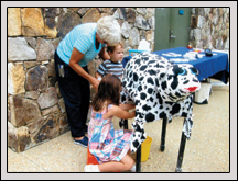 Wake County Farm Bureau Women’s Committee Member Monnie Jenks showed children how to milk a cow.