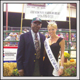Lee County Farm Bureau President John Cameron poses with Katherine Southard, Miss North Carolina 2009, during the Meat Goat Show.