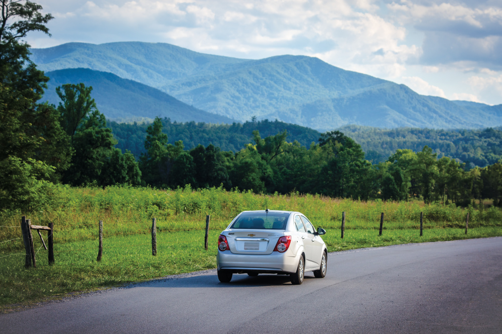 Visitors drive past scenic mountain vistas on the Cade's Cove Loop in the Great Smoky Mountains National Park near Townsend, Tennessee.