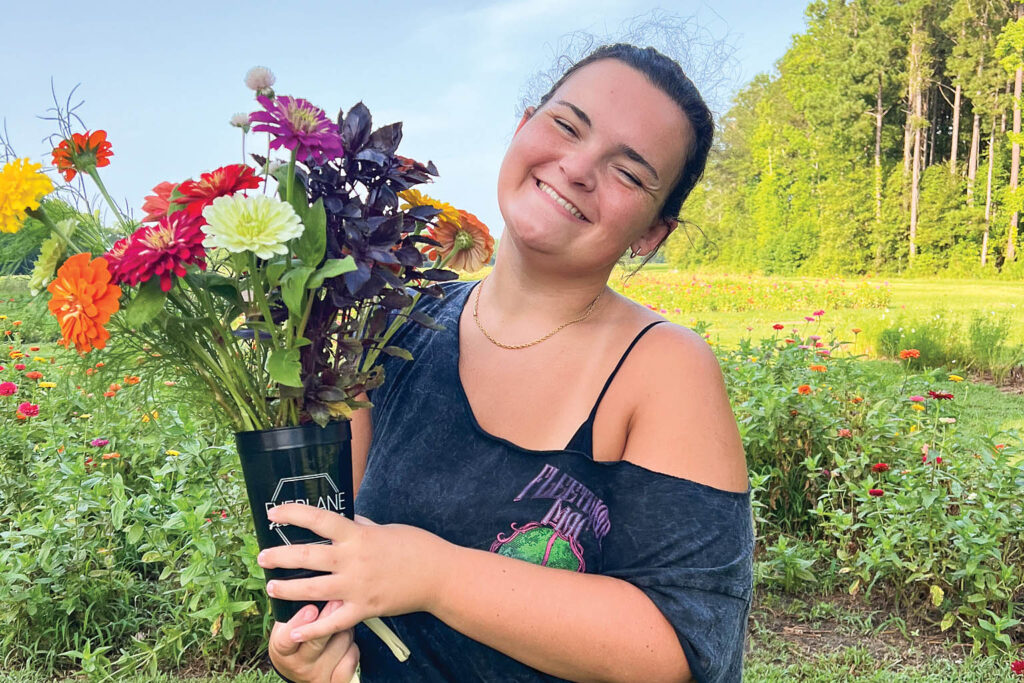 Everlane Flower Co. farmhand, Caroline Hunt, enjoys freshly picked flowers
