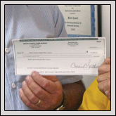Bertie County Farm Bureau President Joey Baker, left, presents a check to David Early, Region One Coordinator for North Carolina Baptist Men’s Association.