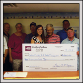 From left, Carteret County Farm Bureau board member Ray Harris, Rusty Bryan, Treasurer June Bryan, Herbert Page, Carteret County 4-H Program Assistant Danielle Clark, Henry Davis, Greg Garner, President Mickey Simmons and Ray Garner presented a check to Carteret County 4-H.