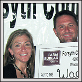 From left, Stephanie Miller and Forsyth County Farm Bureau member Wade Jurney receive a $5,000 donation presented by Forsyth County Farm Bureau President Edgar Miller.