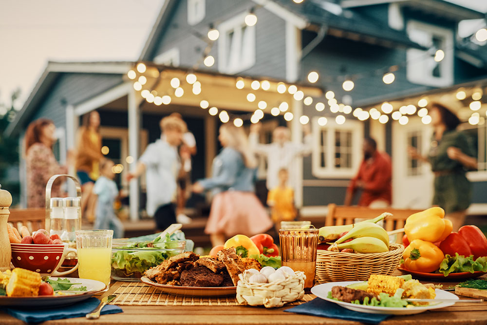 Outdoors Dinner Table with Gorgeous-Looking Barbecue Meat, Fresh Vegetables and Salads.