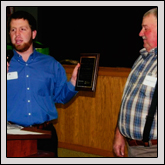 Jacob Morgan, left, presents the 2011 Farmer of the Year Award to Board Member Michael Shepherd.
