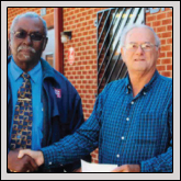 Farm Bureau President John Cameron, left,presents a check to George Noel, Breadbasket board member.