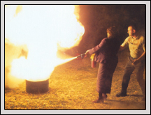 Kenansville firefighter Lee Graham shows women’s committee member Ann Lyles the proper way to use a fire extinguisher. 