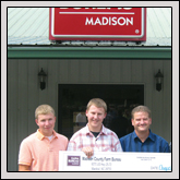 From left, Madison High School students Bill Jones and Jacob Freeman and teachers Harvey Franklin and Chuck Michaels accept a $1,500 donation from Madison County Farm Bureau, presented by President Jackie Ball.