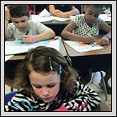 Highfalls Elementary first-and-second-graders make labels for collection tins.